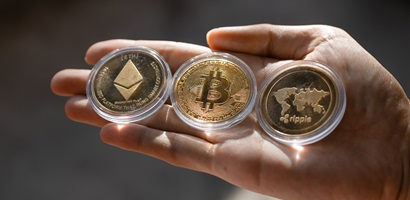 young man holding crypto tokens bitcoin ethereum 2022 12 16 09 58 35 utc